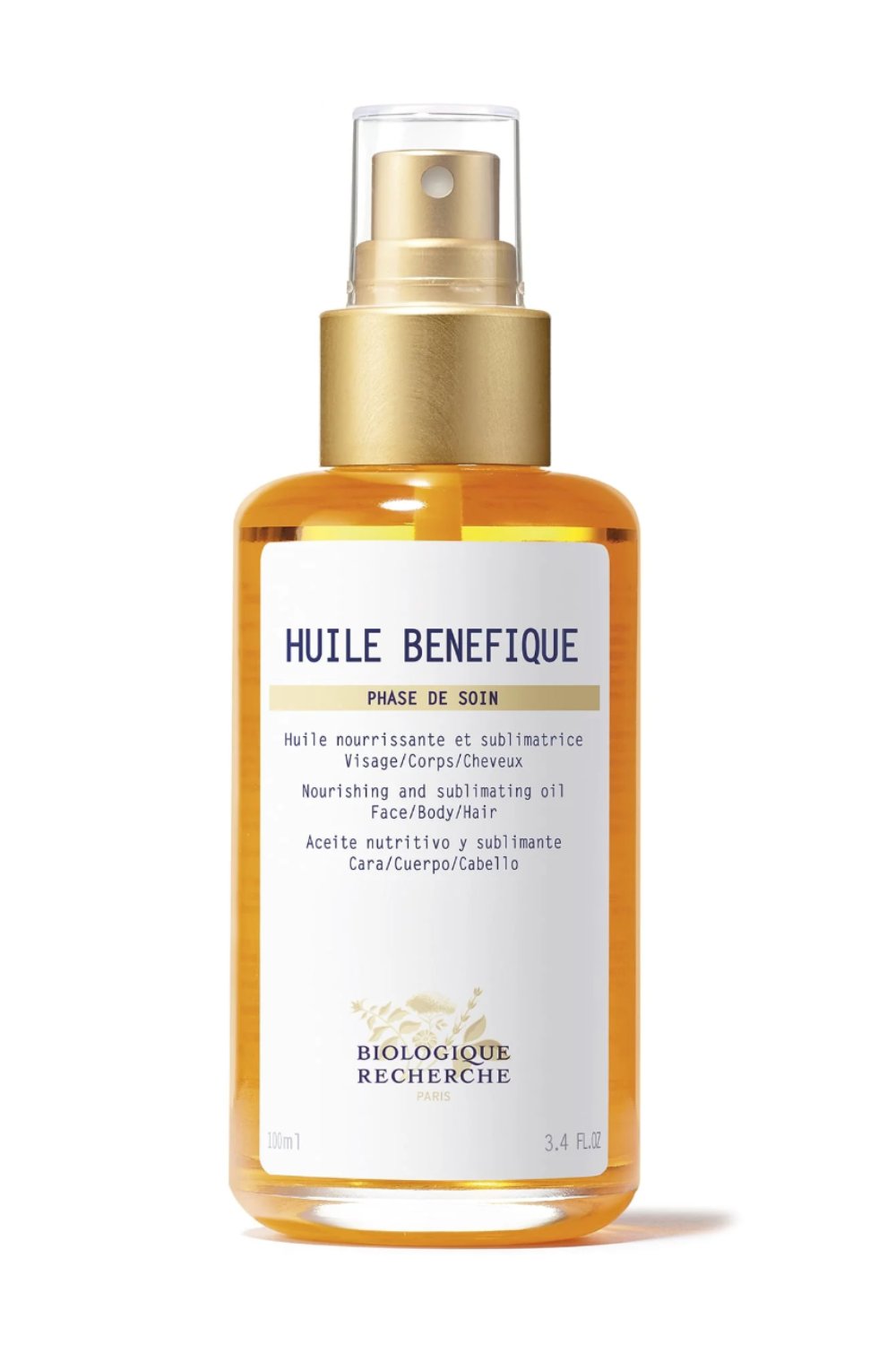 A 100ml bottle of Biologique Recherche Huile Bénéfique with a spray nozzle. The label details its use for face, body, and hair nourishment and sublimation.