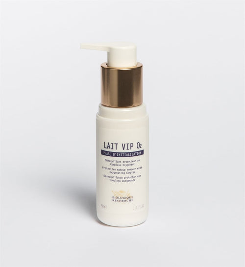 A white pump bottle of Original Formula - Biologique Recherche Lait VIP O2 cleanser with gold accents, designed to unify complexion and protect urban skin, stands upright on a plain white background.