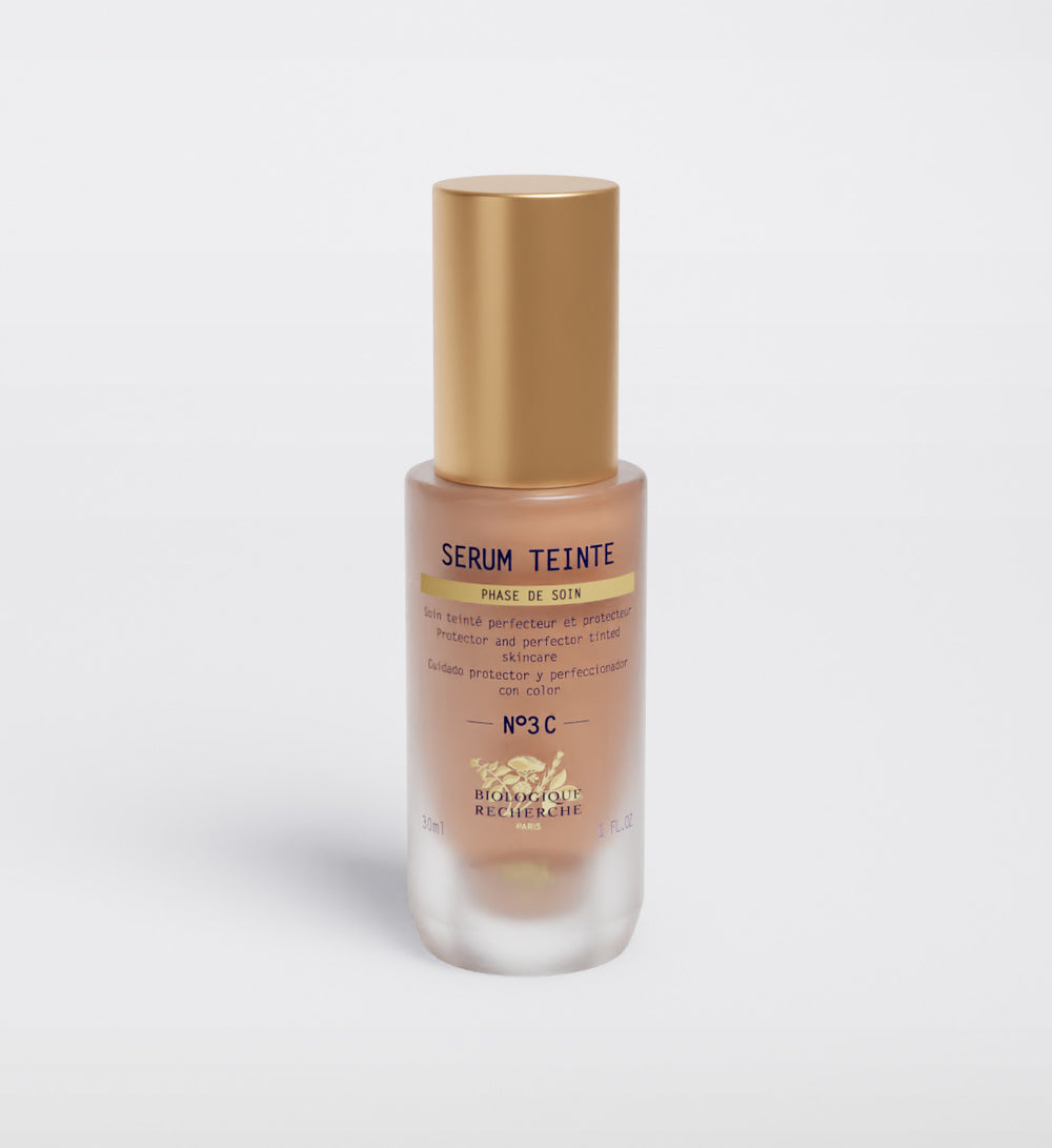 The Biologique Recherche Serum Teinte N3 Cold features a gold cap, product info text on the front, and offers photo-protecting properties for radiant skin.