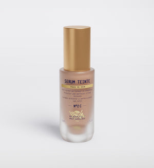 Biologique Recherche Serum Teinte N2 Cold features a gold cap and transparent design that reveals its "protecteur et perfecteur" contents, ensuring skin perfection and photo protection for an elegant skincare routine.