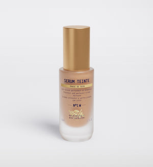 The "Biologique Recherche Serum Teinte N1 Warm" face serum, topped with a gold cap, promises to perfect and protect your skin with a hint of color for impeccable results.