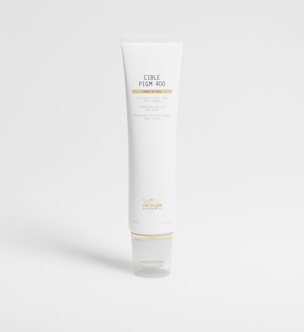 A white tube labeled "Cible PIGM Creme" stands upright on a plain white background, promising precise application to target pigmentation for a more radiant complexion.