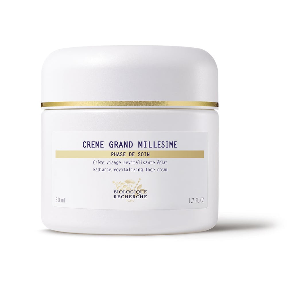 White jar of "Biologique Recherche Crème Grand Millesime" face cream, labeled as a revitalizing radiance beauty cream for devitalized skin.