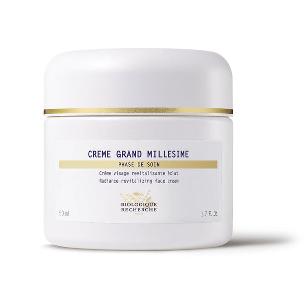 White jar of "Biologique Recherche Crème Grand Millesime" face cream, labeled as a revitalizing radiance beauty cream for devitalized skin.