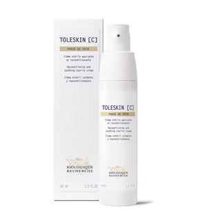 White bottle of Biologique Recherche Creme Toleskin, a sterile reconditioning and soothing cream for sensitive, red skin, beside its matching box.