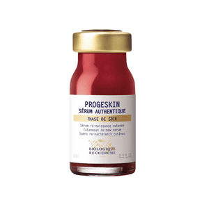 The Biologique Recherche Serum Progeskin, 0.3 oz, features a small bottle with a red bottom and gold cap, providing deep hydration and enhancing skin firmness for revitalization.
