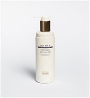 A white plastic bottle with a gold pump labeled "Biologique Recherche Lait VIP O2 - 8.4 oz," crafted for urban skin, offers an antipollution cleanse to revive devitalized skin.