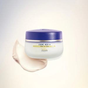 A white jar with a purple lid labeled "Biologique Recherche Crème MSR-H," a menopause skin care essential, sits beside a cream smear on a light gradient background.