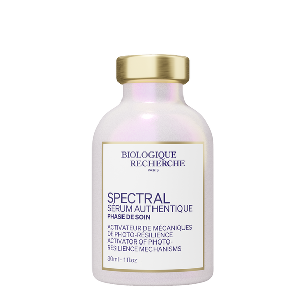 A 30ml bottle of Biologique Recherche Spectral Serum features a gold cap and a white label with product details in both French and English.