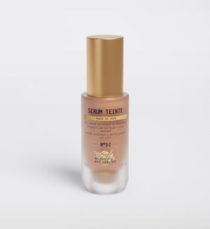 The Biologique Recherche Serum Teinte N3 Cold features a gold cap, product info text on the front, and offers photo-protecting properties for radiant skin.