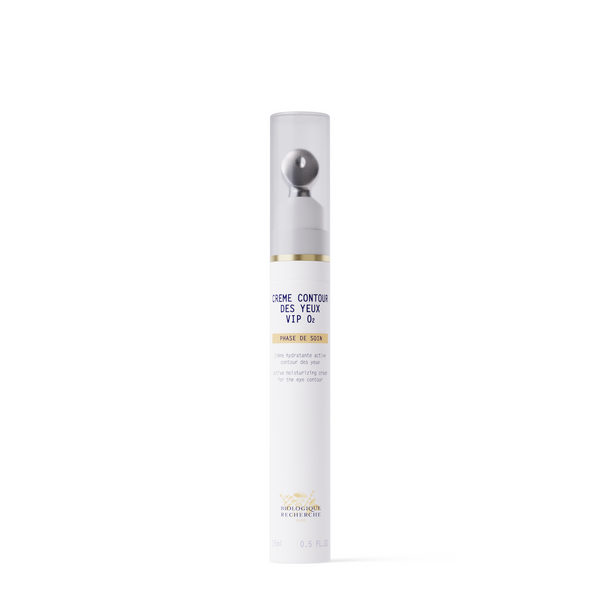 A white cylindrical bottle of New Formula - Creme Contour des Yeux VIP O2 eye cream with a metallic roller applicator and clear cap, designed to target dark circles, stands upright on a plain white background.