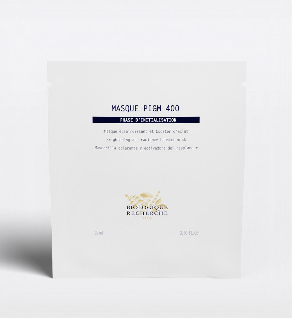 The Biologique Recherche Masque PIGM 400, a brightening face mask targeting uneven pigmentation and enhancing radiance, is shown in its white packet against a plain background.