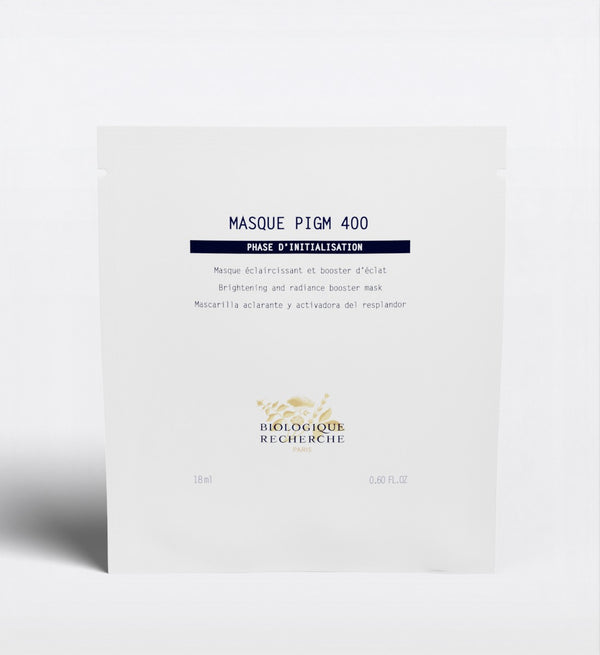 The Biologique Recherche Masque PIGM 400, a brightening face mask targeting uneven pigmentation and enhancing radiance, is shown in its white packet against a plain background.