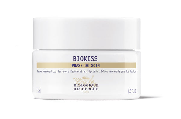 A white jar of Biologique Recherche BioKiss Nourishing Lip Balm, labeled "Phase de Soin," features botanical lipids for nourishing care and contains 0.5 fl oz.