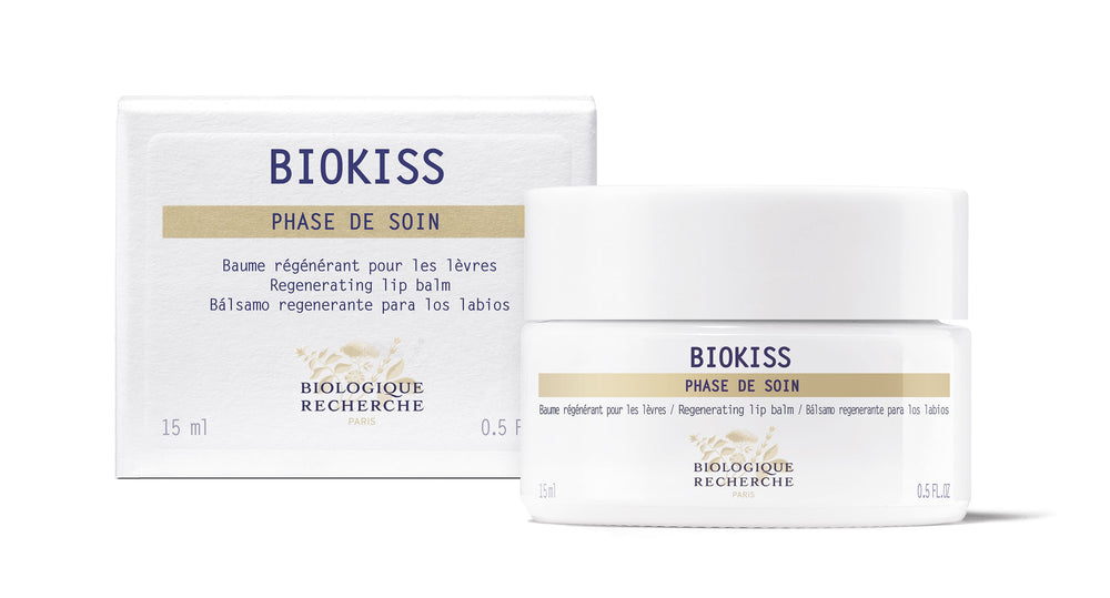 A white jar of Biologique Recherche BioKiss Nourishing Lip Balm, labeled "Phase de Soin," features botanical lipids for nourishing care and contains 0.5 fl oz.