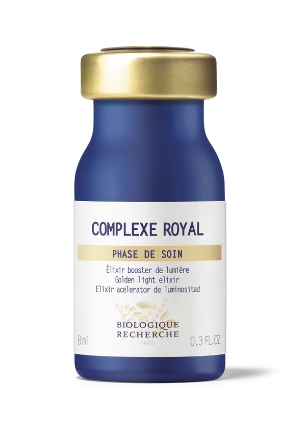 An 8 ml blue and gold bottle of "Biologique Recherche Complexe Royal" features the "Golden Light Elixir," enriched with Royal Jelly, crafted to rejuvenate alipidic skin.