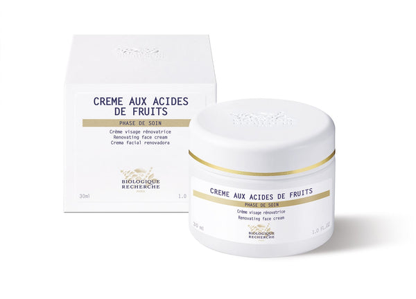 A white jar of Biologique Recherche Crème Aux Acides De Fruits with a Fruit Acid Complex is stylishly positioned beside its matching white box.