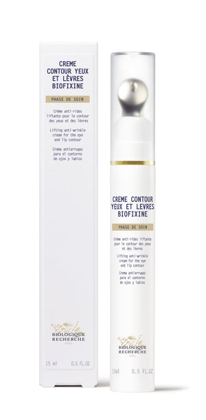 Biologique Recherche Crème Contour Yeux et Lèvres Biofixine in a white bottle with a silver pump, next to its box. Ideal for fine lines and dark circles. 15 ml, 0.5 fl oz.