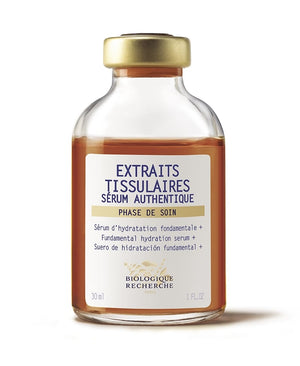 Glass bottle labeled "Serum Extraits Tissulaires," featuring a white and red label with brown liquid, 30 ml.