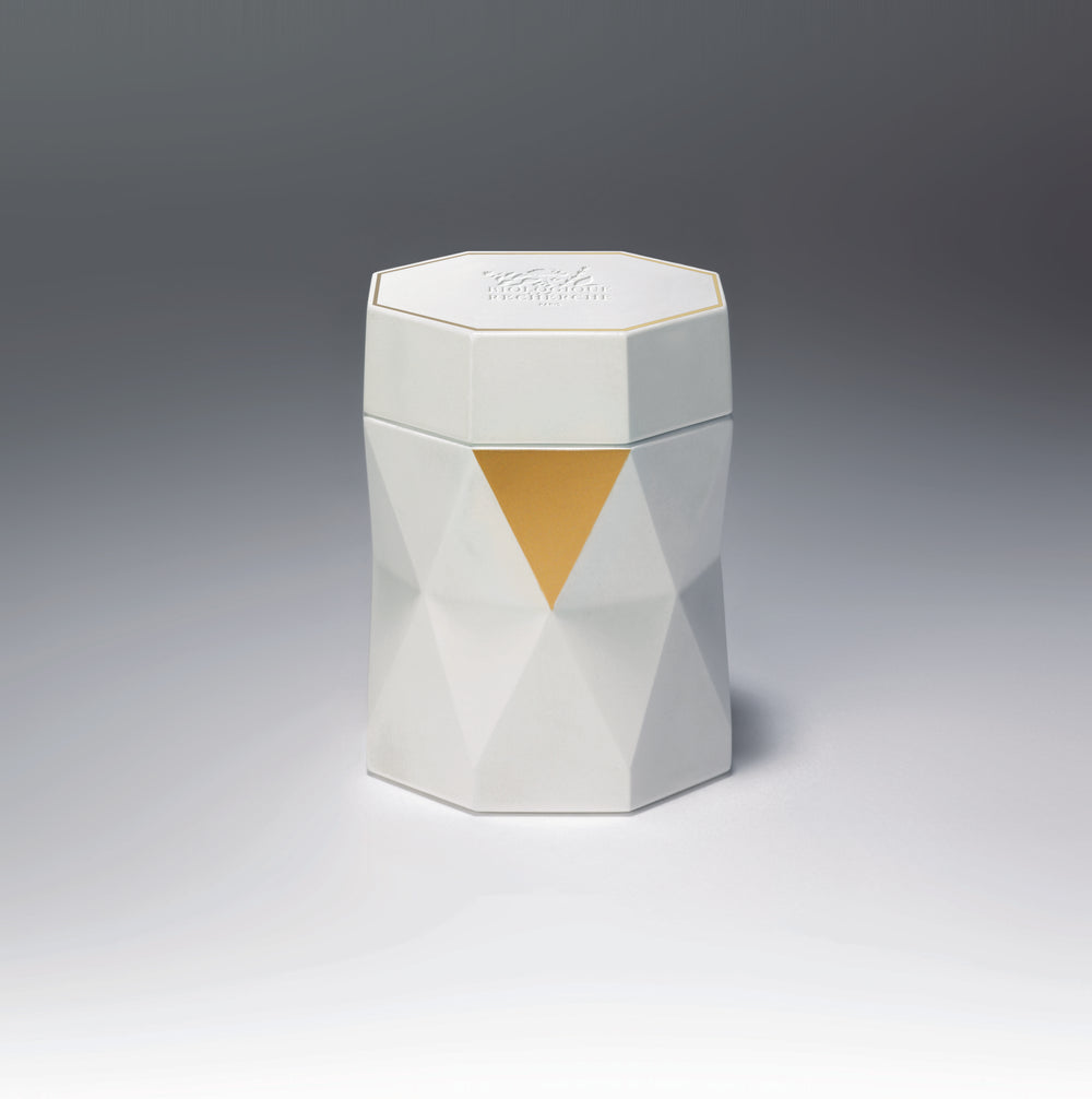 The luxurious Biologique Recherche La Grande Crème, an anti-aging skincare product, showcases a geometric cream jar alongside an open golden box and a closed white box with its name. It's skillfully crafted with professional cosmetics expertise for cellular regeneration.