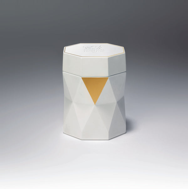 The Biologique Recherche La Grande Crème is presented in a white, geometric, faceted jar with a yellow triangular accent on the front, set against a gradient background, capturing the essence of professional cosmetics.