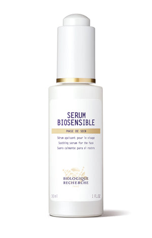 The Biologique Recherche Serum Biosensible features a white bottle with a gold-accented cap and includes French and Spanish text. This soothing serum, perfect for sensitive skin, is available in a 1.0 oz size.