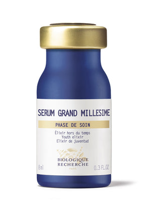 The Biologique Recherche Serum Grand Millesime, in a 0.3 oz blue and gold bottle with French and English text, is a luxurious anti-aging treatment enriched with hyaluronic acid for hydration and antioxidants to protect against environmental damage.