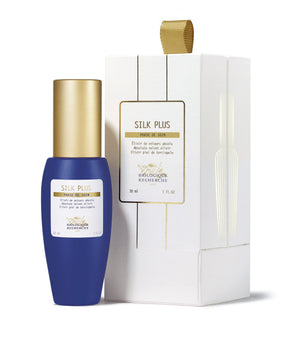 A 1 oz blue and gold bottle labeled "Biologique Recherche Silk Plus" sits elegantly next to its white and gold packaging, offering a moisturizing serum with Hyaluronic Acid for ultimate skin smoothing.