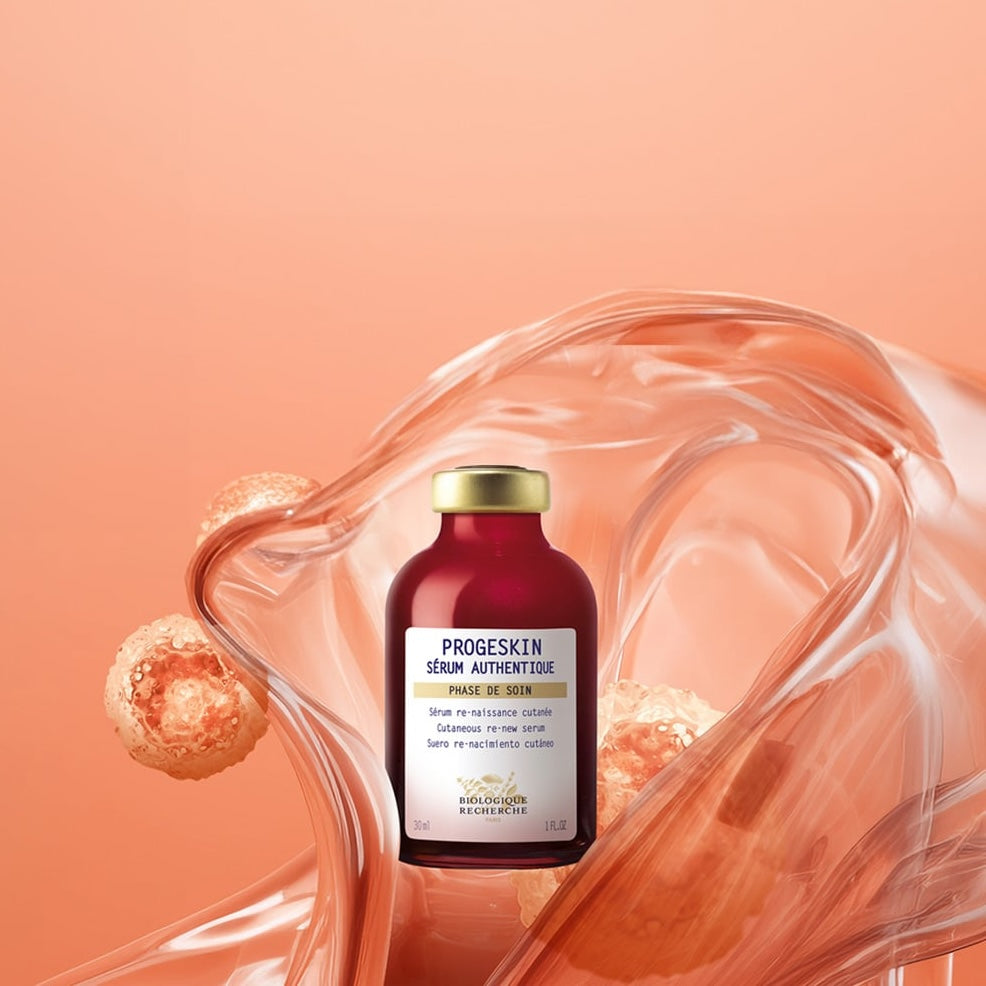 The Progeskin - 0.3 oz serum by Biologique Recherche comes in a small reddish bottle with a gold cap, designed to enhance skin firmness and elasticity.